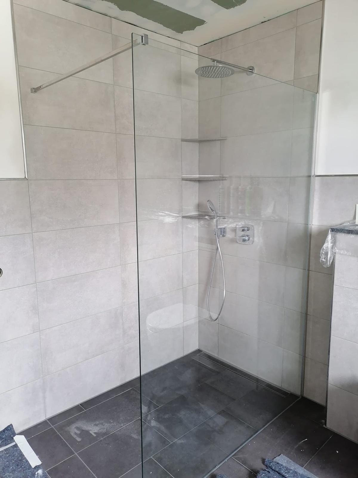 Von Graefe e.K. ausgeführte bodennahe Dusche mit Glasabtrennung